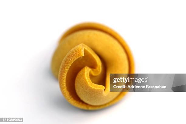 dry spiral pasta on white background - tortellini bildbanksfoton och bilder