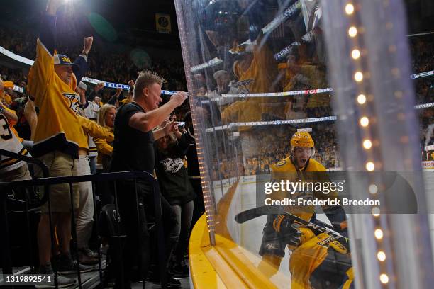 Fans of the Nashville Predators cheer after as Calle Jarnkrok congratulates teammate Luke Kunin on scoring the game winning goal during the second...