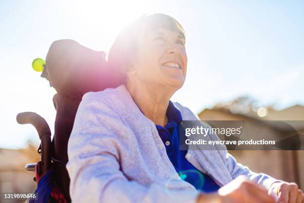 mature adult female with disability living life to the fullest photo series - motorized wheelchair stock pictures, royalty-free photos & images