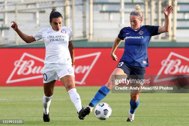 Marta of the Orlando Pride and Kristen Hamilton of the North Carolina Courage challenge for the ball during a game between Orlando Pride and North...