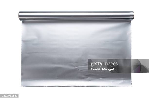 roll of opened aluminum foil on white - carta stagnola foto e immagini stock