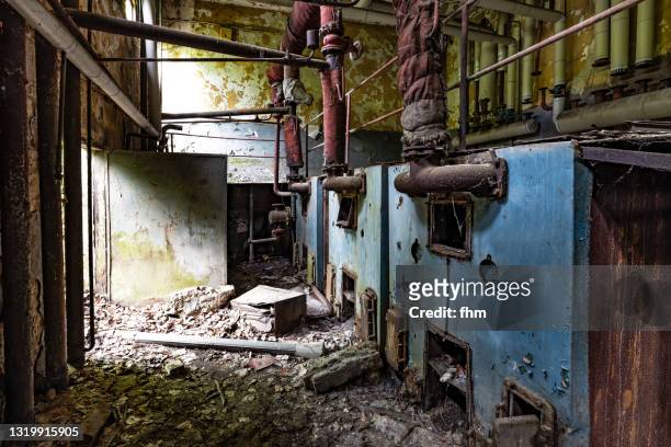 old heating boilers in an abandoned building - broken boiler foto e immagini stock