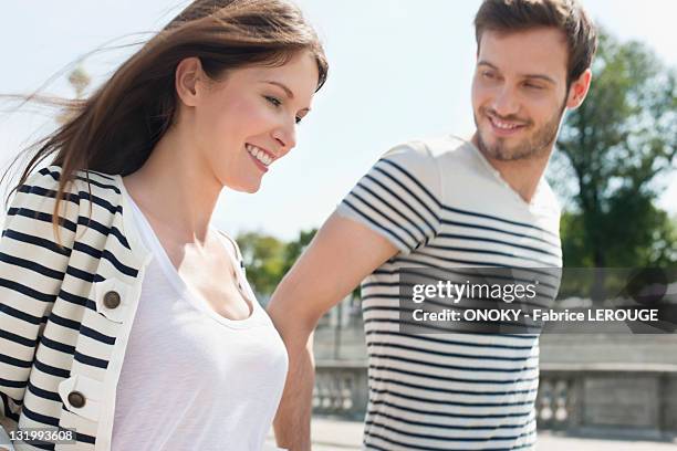 couple walking together, paris, ile-de-france, france - zeemansstrepen stockfoto's en -beelden