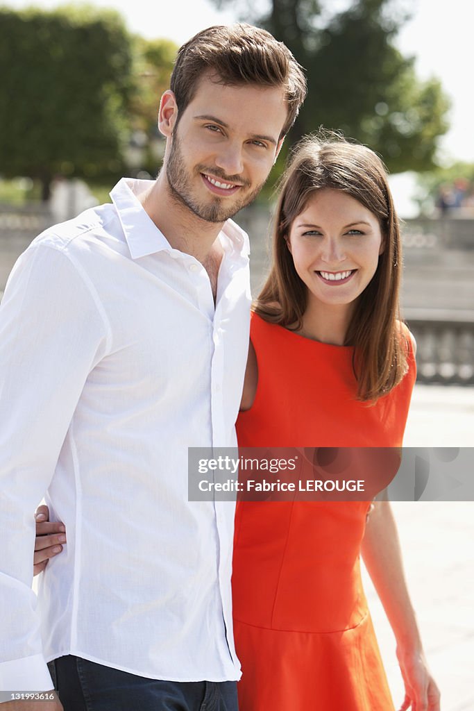 Couple walking with arms around and smiling, Paris, Ile-de-France, France