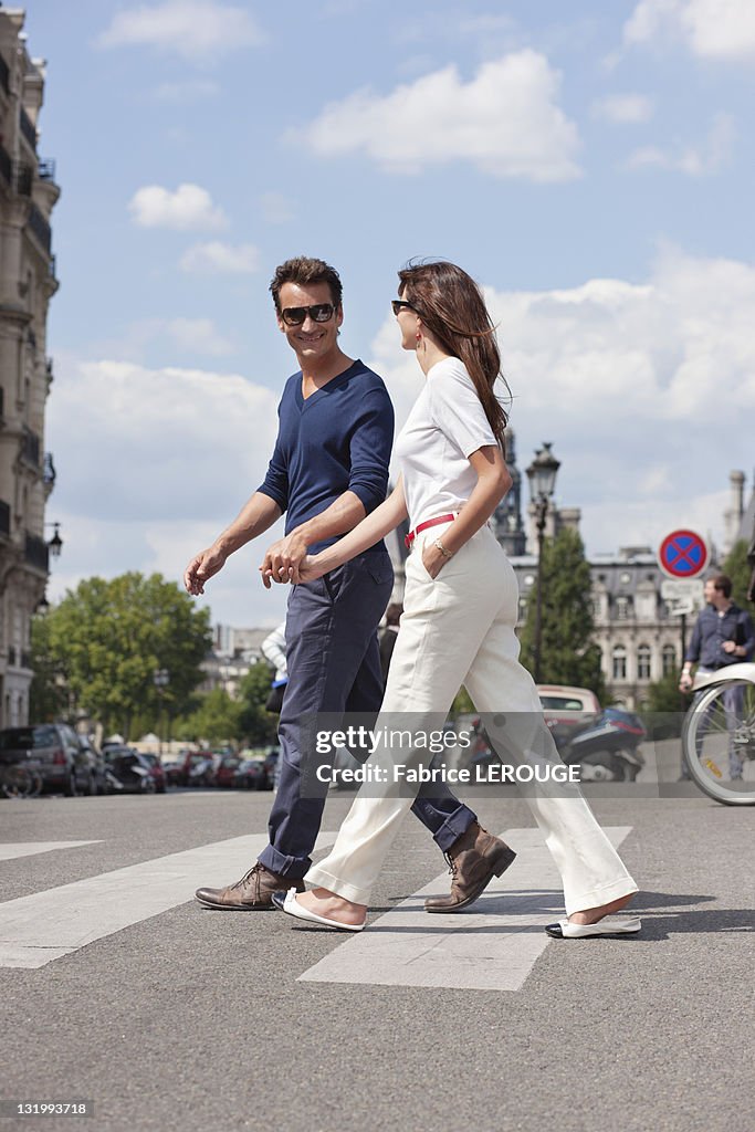 Couple crossing the road, Paris, Ile-de-France, France