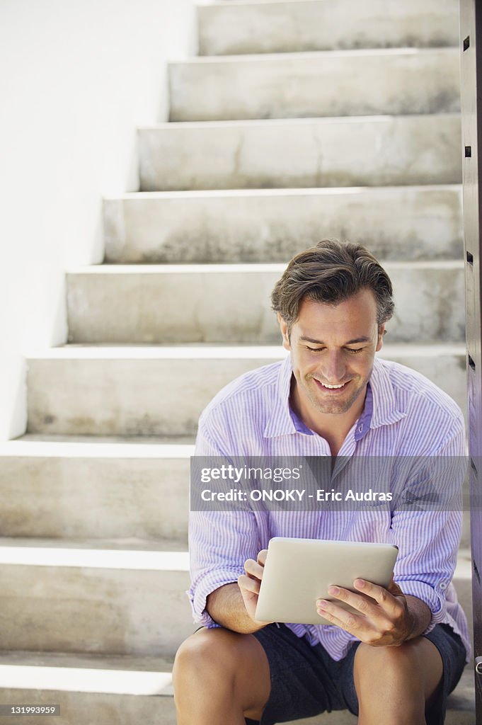 Mid adult man using a digital tablet