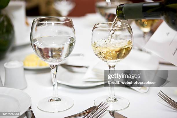 pouring wine - water glass table stock pictures, royalty-free photos & images