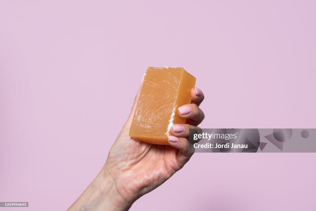 Close-up of a hand holding a bar of soap