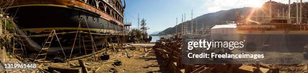 panoramic looking at boat building in dry dock, turkey - holzeisenbahn stock-grafiken, -clipart, -cartoons und -symbole