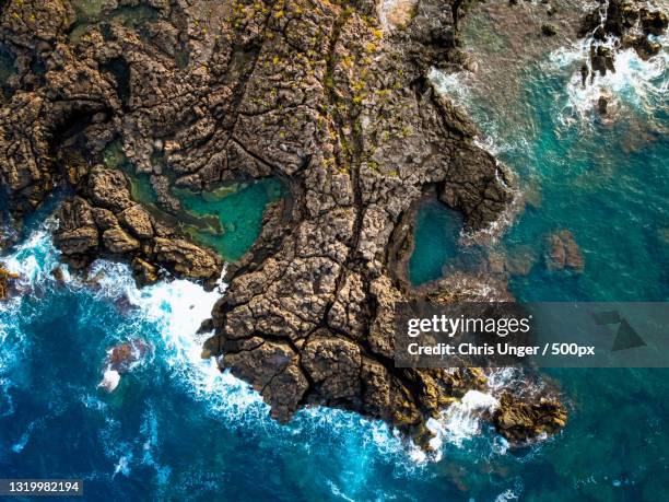 high angle view of rock formation in sea,naxos,messina,italy - naxos sizilien stock-fotos und bilder