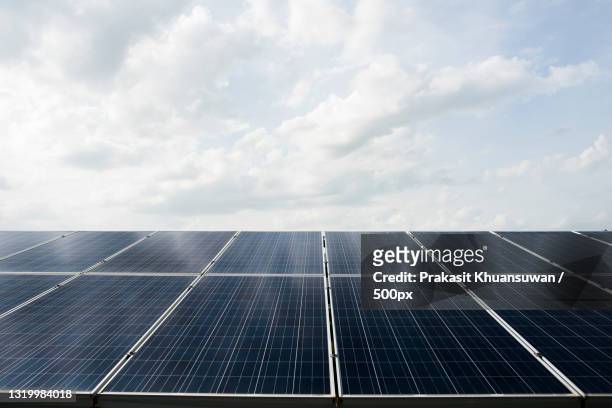 low angle view of solar panels against sky - panal stock-fotos und bilder