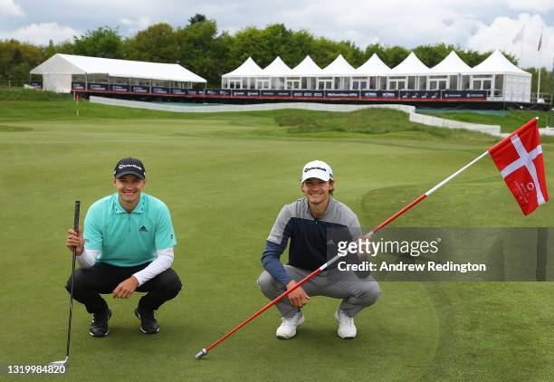 Rasmus Højgaard of Denmark and Nicolai Højgaard of Denmark pose for a photograph on the first green during a practice day prior to the start of Made...