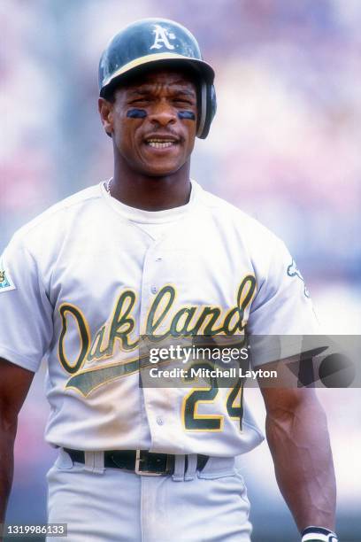 Ricky Henderson of the Oakland Athletics looks on during a baseball game against the Texas Rangers on April 12, 1992 at Arlington County Stadium in...