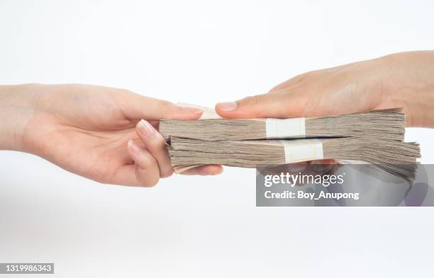 cropped shot of someone giving piles of money banknotes to other isolated on white background. - receiving fotografías e imágenes de stock