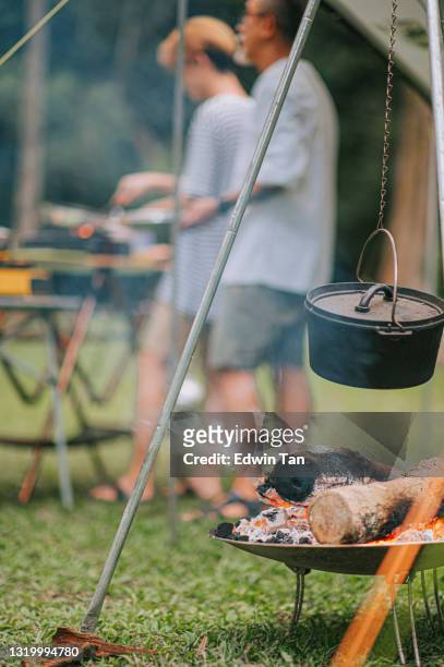 abendlichlagerfeuer während einer campingreise cauldron auf einem brennenden feuer holz hintergrund familie beschäftigt vorbereitung abendessen - ruß stock-fotos und bilder