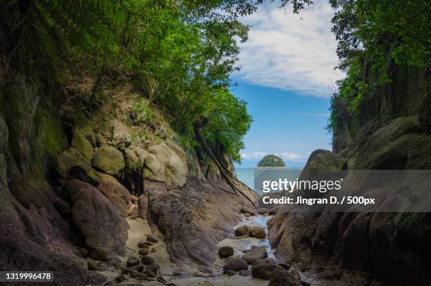 scenic view of rocks by sea against sky,moonraker way,kaiteriteri,new zealand - kaiteriteri stock pictures, royalty-free photos & images