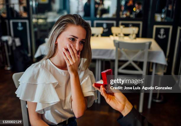 they ask a young blonde woman to marry him. - verlobung stock-fotos und bilder