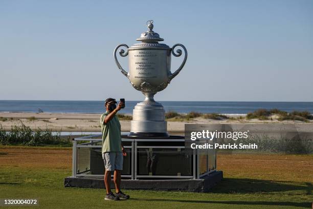 Fan wears a face covering due the Covid-19 pandemic as they take selfie in front of a replica of the Wanamaker Trophy before the start of the 2021...