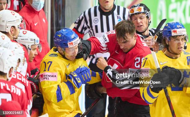 Timo Meier of Switzerland fights against Par Lindholm of Sweden during the 2021 IIHF Ice Hockey World Championship group stage game between...