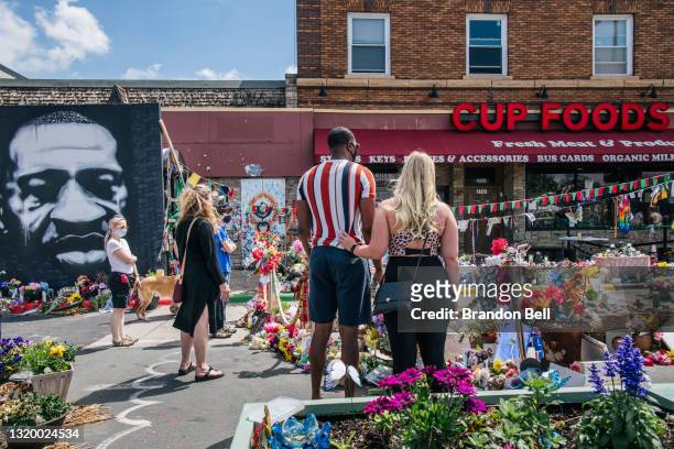 People pays their respects to George Floyd in the intersection of 38th Street and Chicago Avenue on May 25, 2021 in Minneapolis, Minnesota. People...