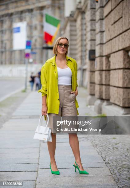 Tina Haase is seen wearing Inwear leather Bermudas, white Jacquemus bag, lime green Uterque shirt, Zara heels in green on May 25, 2021 in Berlin,...