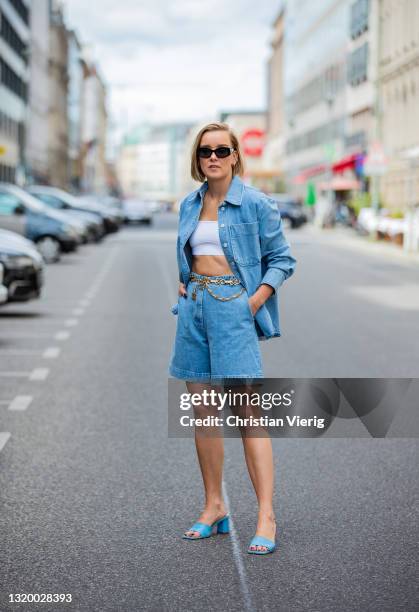 Tina Haase is seen wearing Baum & Pferdgarten denim shirt and shorts, Chanel belt, Max Mara sunglasses, Zara heels in blue on May 25, 2021 in Berlin,...