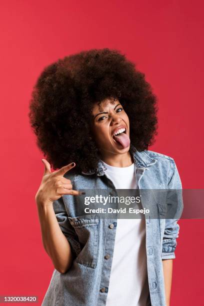 expressive black woman showing rock gesture in studio - pictogram independent stock pictures, royalty-free photos & images