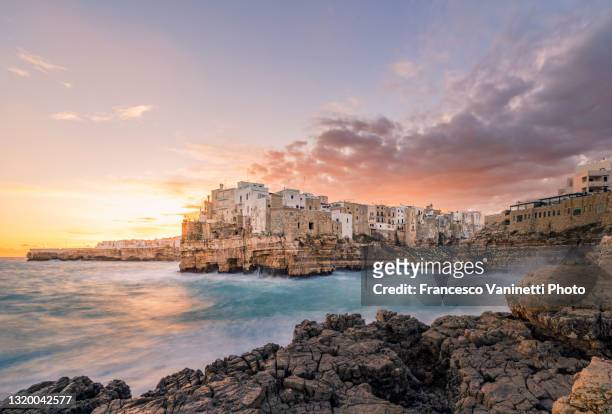 polignano a mare at sunrise, italy. - puglia italy stock pictures, royalty-free photos & images