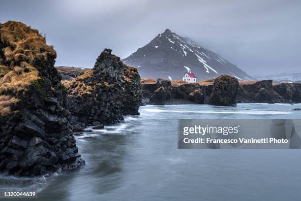 arnarstapi village and stapafell mountain in winter, iceland. - snaefellsnes stock pictures, royalty-free photos & images