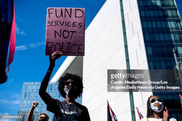 Janee Lennox, of Culver City, joins a Black Lives Matter rally outside LAPD Headquarters in Los Angeles during the first anniversary of George...