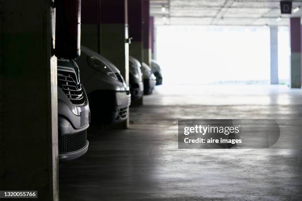 close-up of front bumpers of parked cars in parking lot - auto garage foto e immagini stock