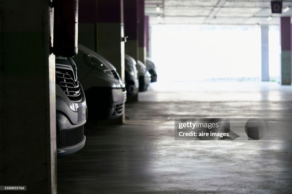 Close-up of front bumpers of parked cars in parking lot