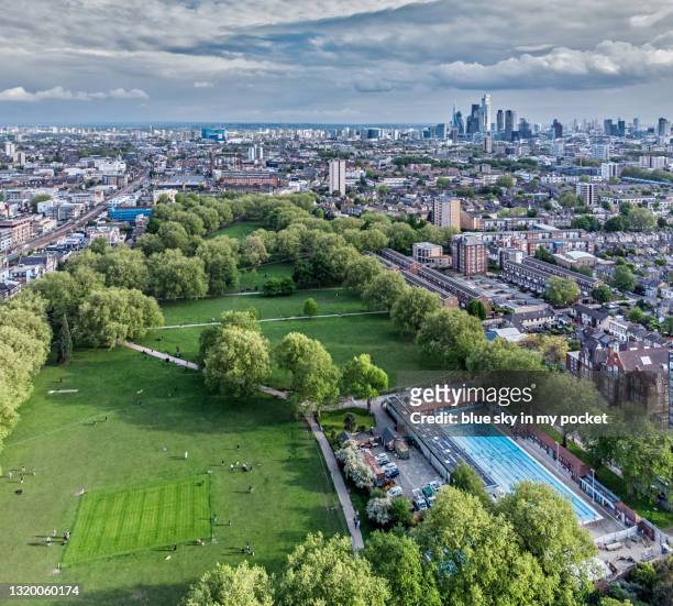 london fields, hackney in east london from a high angle viewpoint with the only heated outdoor lido in the capital - hackney london stock pictures, royalty-free photos & images
