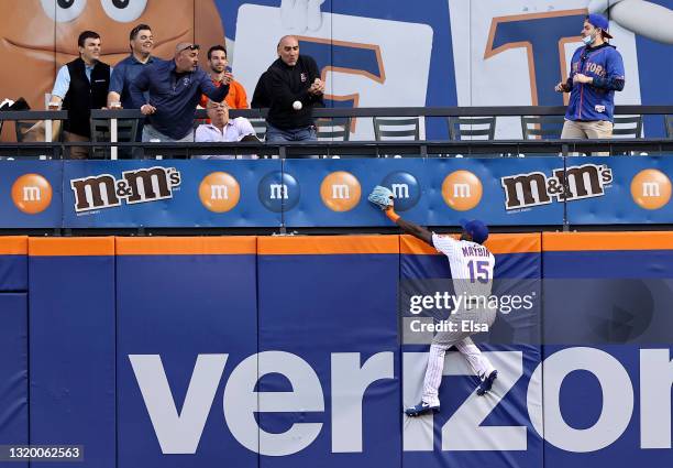 Cameron Maybin of the New York Mets is unable to catch a hit by Ryan McMahon of the Colorado Rockies in the second inning giving McMahon the solo...