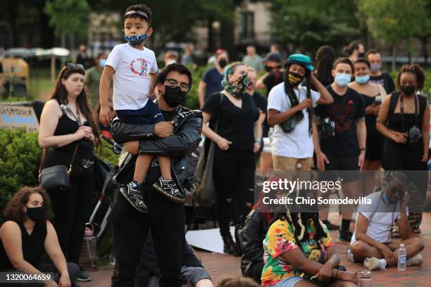 People gather for a vigil on the one-year anniversary of George Floyd's murder in Lafayette Square near the White House on May 25, 2021 in...