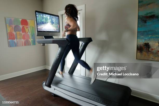 Liza Lecher works out on her Peloton Tread+ treadmill on May 24, 2021 in Williamstown, New Jersey. Earlier this month, Peloton recalled its Tread and...