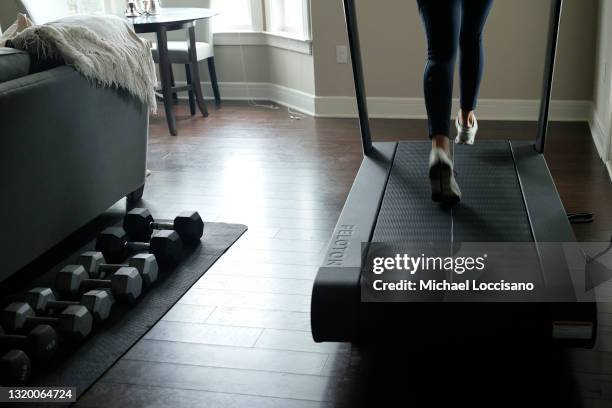 Liza Lecher works out on her Peloton Tread+ treadmill on May 24, 2021 in Williamstown, New Jersey. Earlier this month, Peloton recalled its Tread and...