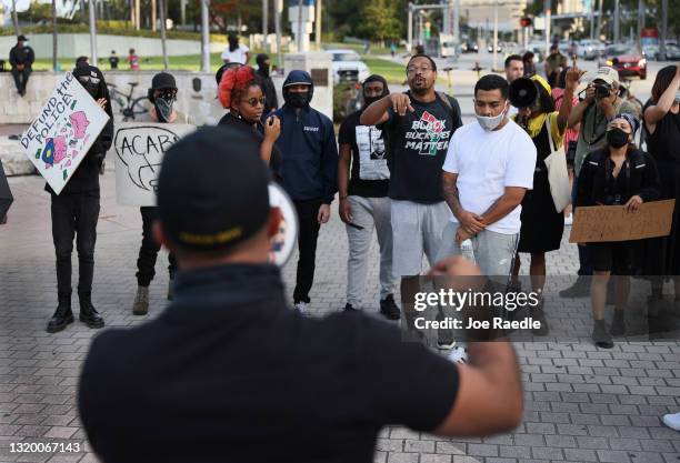 Enrique Tarrio , leader of the Proud Boys, uses a megaphone while counter-protesting people gathered at the Torch of Friendship to commemorate the...