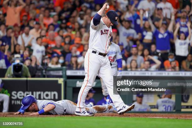 Joe Smith of the Houston Astros is unable to tag out Gavin Lux of the Los Angeles Dodgers at home plate following a wild pitch during the seventh...