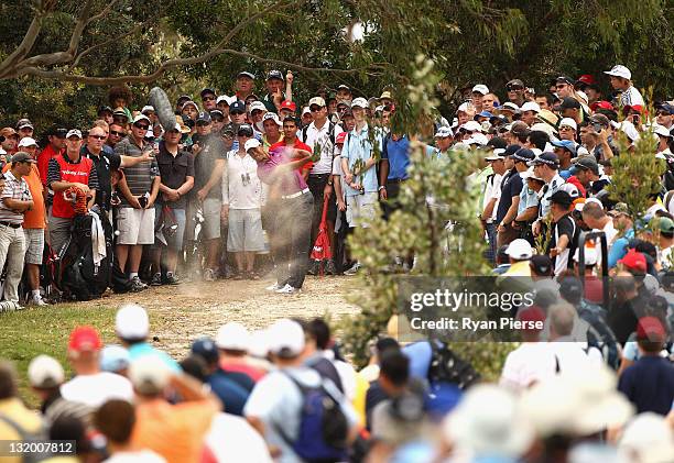 Tiger Woods of the USA hits out of the rough on the 3rd Hole during day one of the 2011 Emirates Australian Open at The Lakes Golf Club at The Lakes...