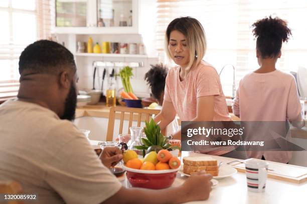 mother taking care family preparing food during breakfast - quarantine cooking stock pictures, royalty-free photos & images