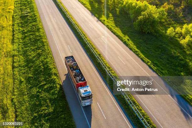 aerial view of truck with metal for recycling  in rural landscape. - trailer trash stock pictures, royalty-free photos & images