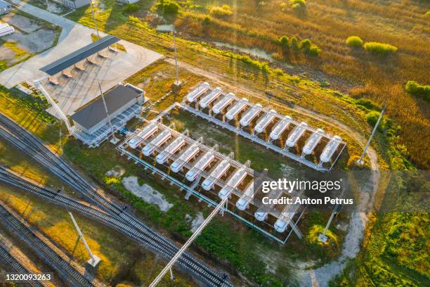 aerial view of gas storage station - fuel storage tank stock-fotos und bilder