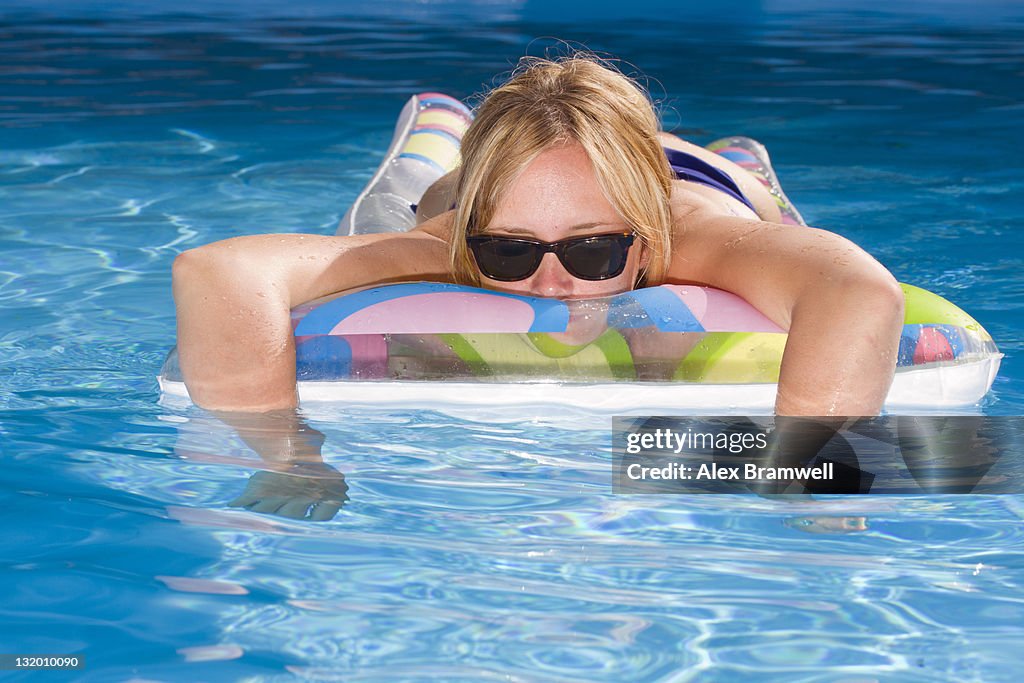 Woman Floating In Pool Woman Floating In Swimming Pool High-Res Stock Photo - Getty Images