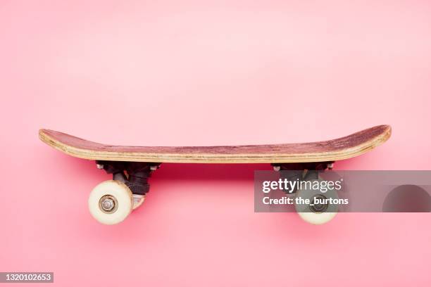 still life of of small skateboard on pink background - skateboard stock pictures, royalty-free photos & images