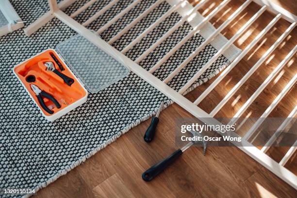 young father assembling baby cot at home - ikea bedroom stock pictures, royalty-free photos & images