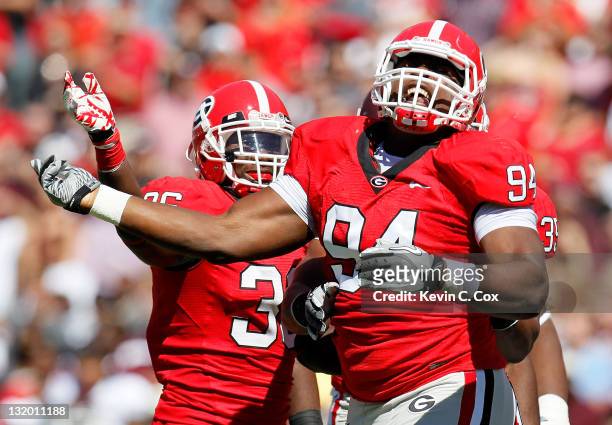 Shawn Williams and DeAngelo Tyson of the Georgia Bulldogs against the Mississippi State Bulldogs at Sanford Stadium on October 1, 2011 in Athens,...