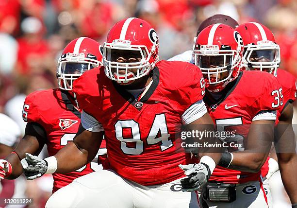 Michael Gilliard and DeAngelo Tyson of the Georgia Bulldogs against the Mississippi State Bulldogs at Sanford Stadium on October 1, 2011 in Athens,...