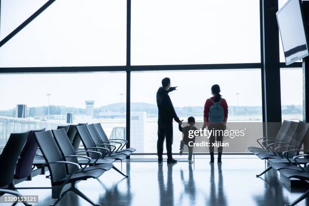 family at the airport  waiting flying - baby gate imagens e fotografias de stock