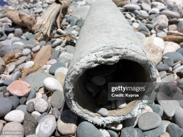 asbestos-pipe on beach - greece - asbestos pipe stock pictures, royalty-free photos & images